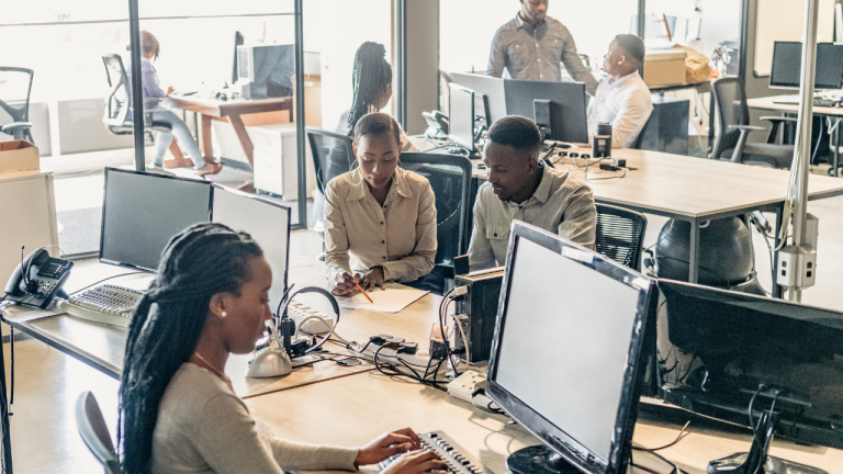 office workers at their desks in an open office